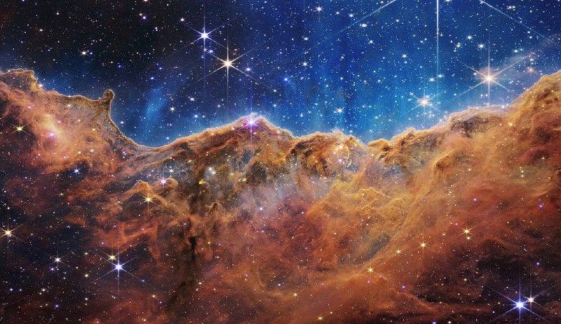 NASA’s Webb Reveals Cosmic Cliffs, Glittering Landscape of Star Birth美国宇航局的韦伯号揭示了宇宙悬崖、恒星诞生的闪亮景观